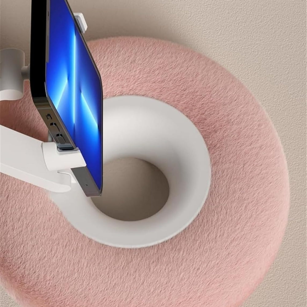Belro fuzzy pillow phone holder with built-in snack bowl, soft fabric cover, and adjustable grip for smartphones.