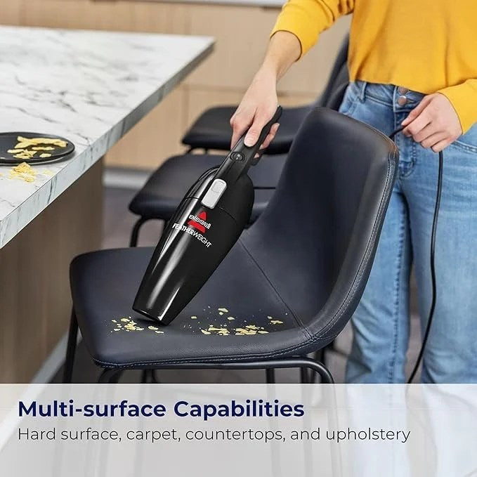 Casavibeo Bissell Featherweight stick vacuum in black with crevice tool, lightweight, bagless design, suitable for quick cleaning.
