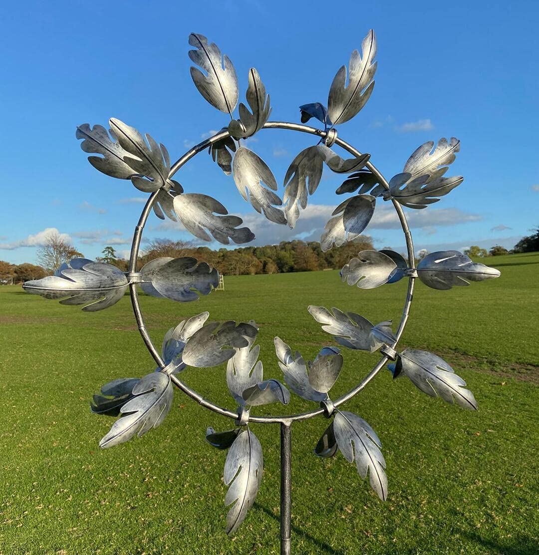 Colorful Belro metal windmill garden spinner spinning in the breeze, decorative kinetic wind sculpture for outdoor home and garden decor.