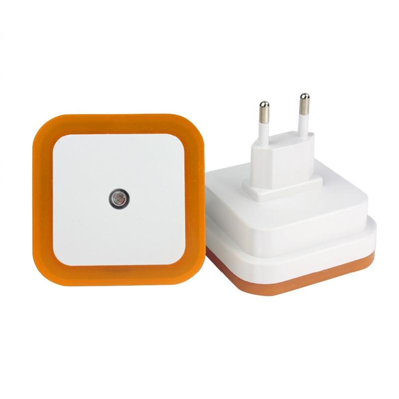 Belro plug-in motion detector smart outlet night light plugged into an electrical outlet, illuminating a room with soft light.