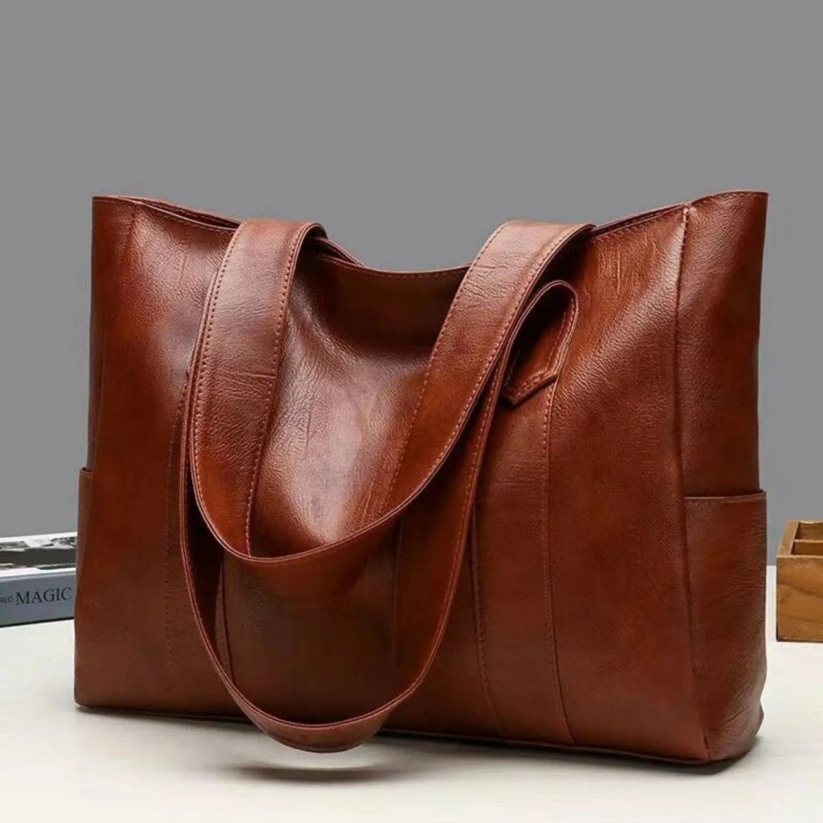 Leather shoulder bag by BowLift featuring vintage chic style, smooth surface, soft texture, and retro elegance.