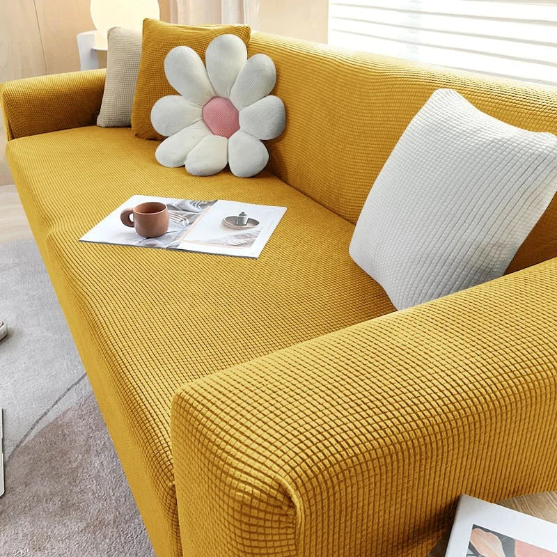 Stretchable Belro sofa cover in a neutral color, designed to fit and protect standard home and garden sofas.