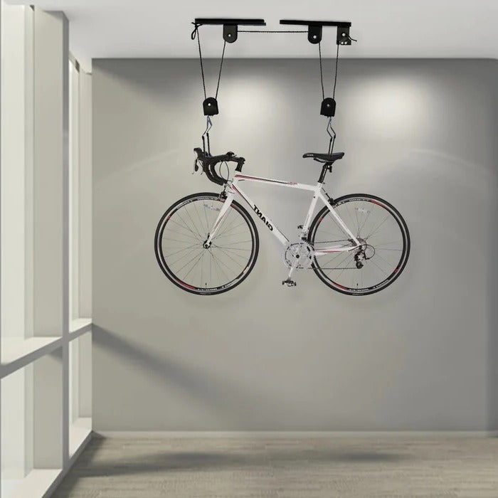 Belro ceiling mounted bike hoist in a home garage, showing the sturdy metal pulley system for easy bike storage and organization.