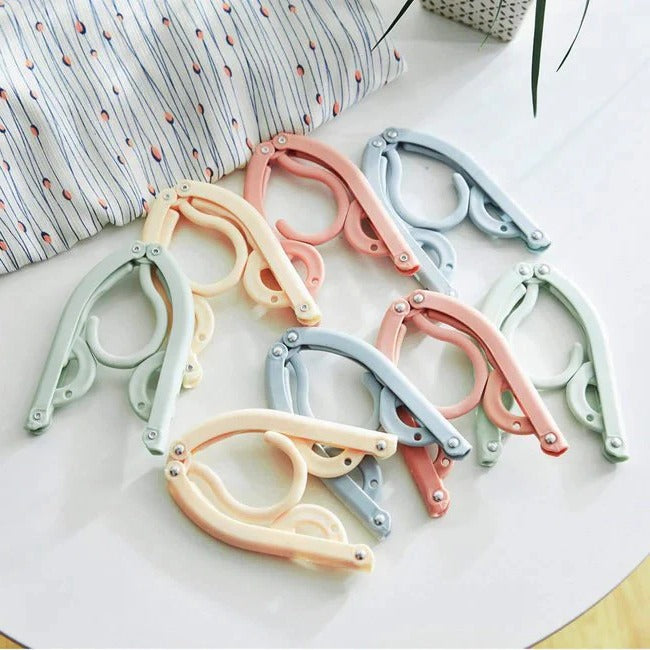 Belro foldable travel clothes hanger with multiple hooks, compact and lightweight for easy packing and organization.