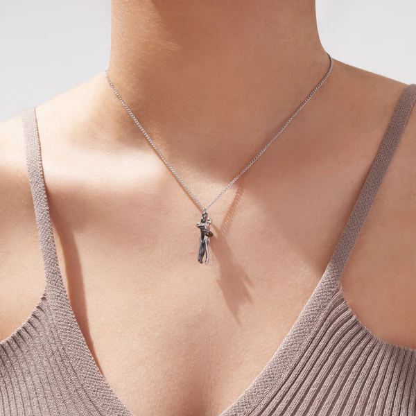 Belro hug necklace with intertwined heart-shaped charms, delicate jewelry accessory for women, on a neutral background.