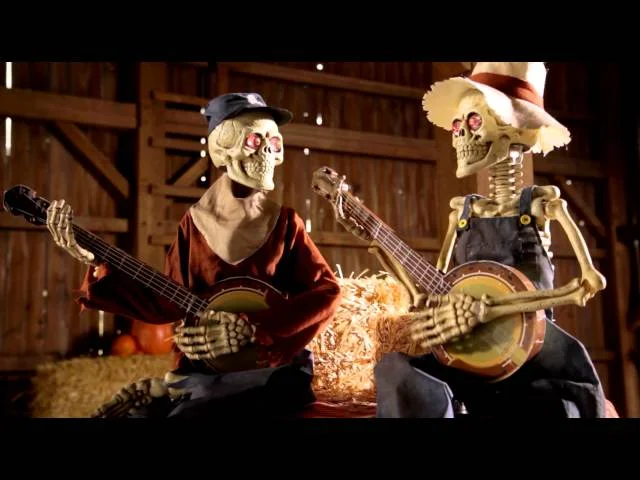 Funny animated dueling banjo skeletons graphic on men's clothing by Belro, featuring skeletons playing banjos in a humorous design.