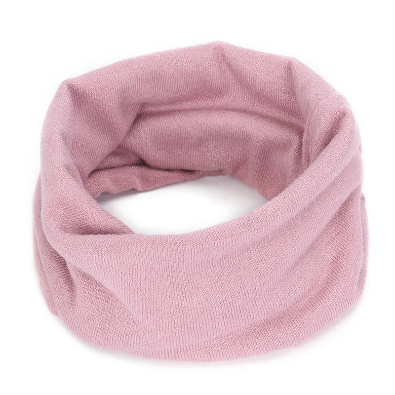Pink Belro cashmere winter scarf and neck warmer, soft and cozy accessory for cold weather, styled as shown in the image.