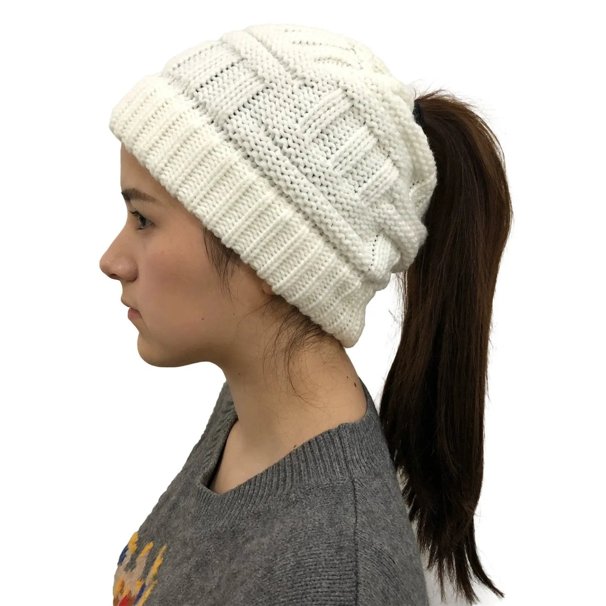 White Belro women’s winter knit beanie with a ponytail opening, cozy and stylish winter hat for women.