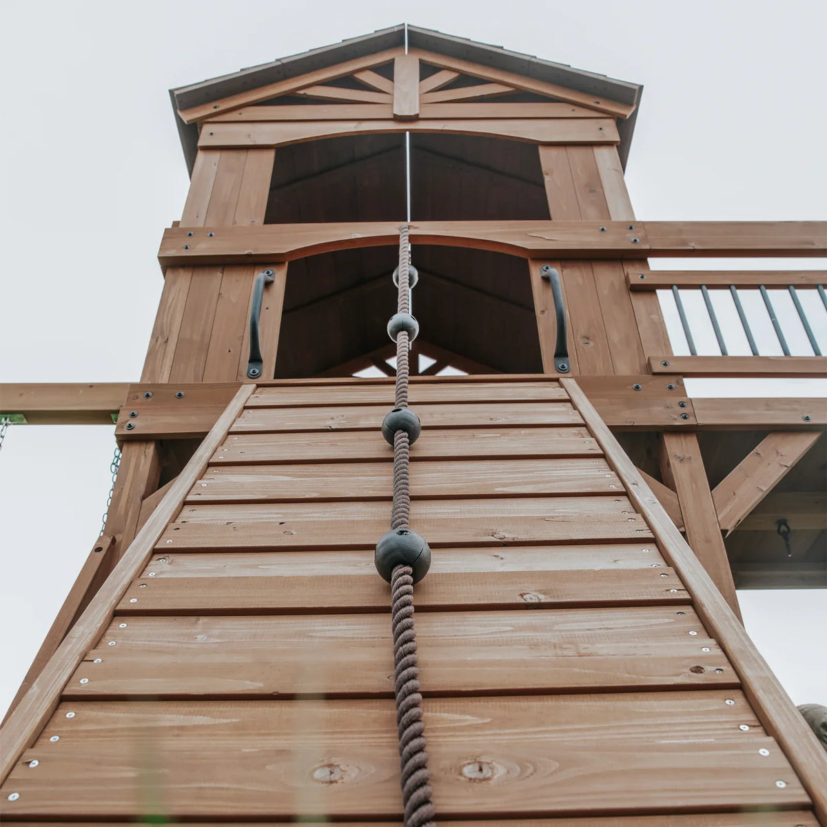 Casavibeo Sterling Point swing set with rope wall for backyard play, featuring sturdy wooden frame and colorful climbing elements.