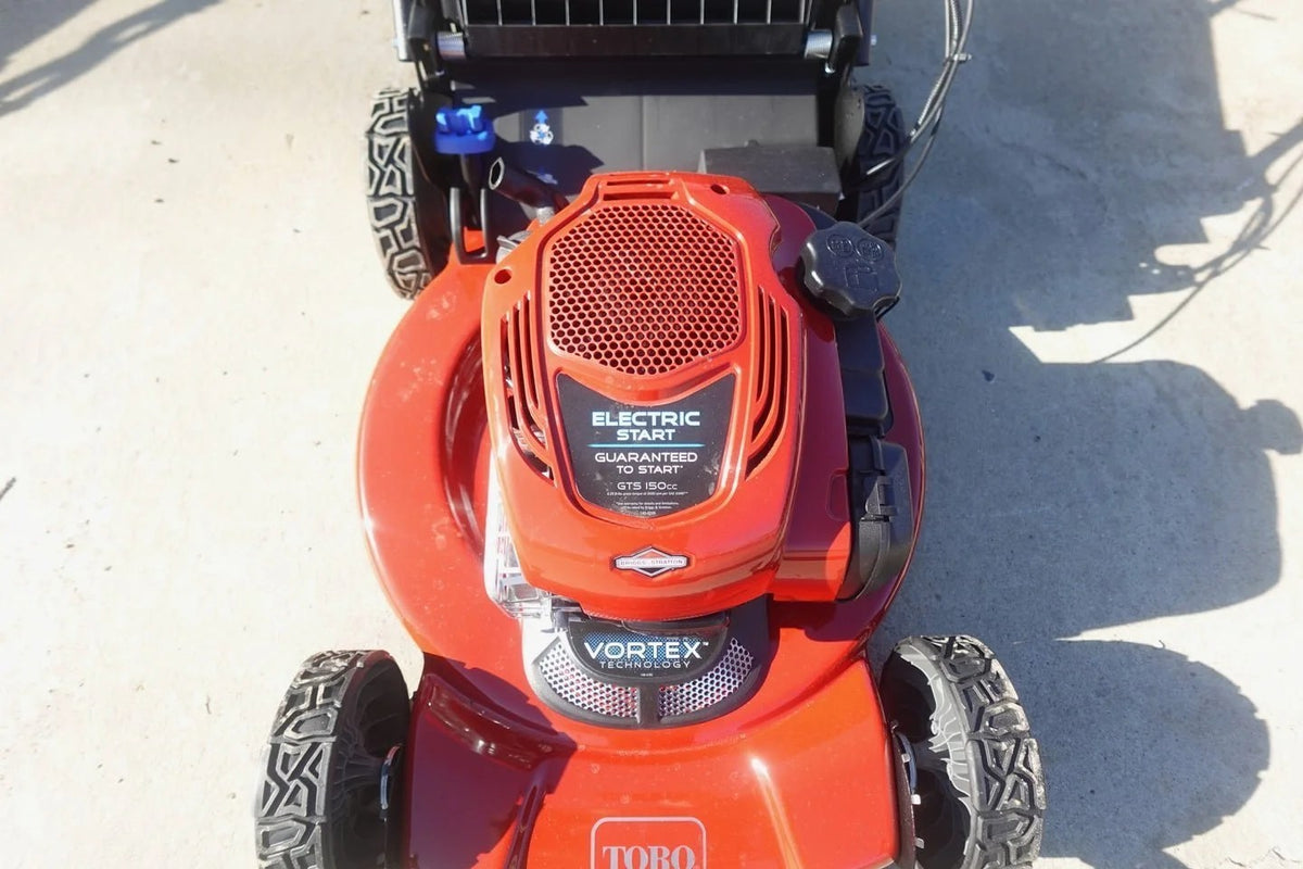 Casavibeo Toro 22-inch Recycler SmartStow electric lawn mower with grass collection bag and adjustable handle in a yard setting.