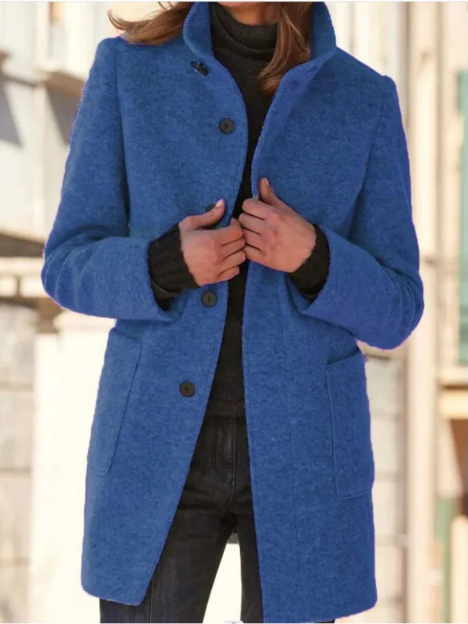 Elegant Belro wool coat displayed on a hanger, showcasing its classic design and cozy fabric for stylish winter wear.