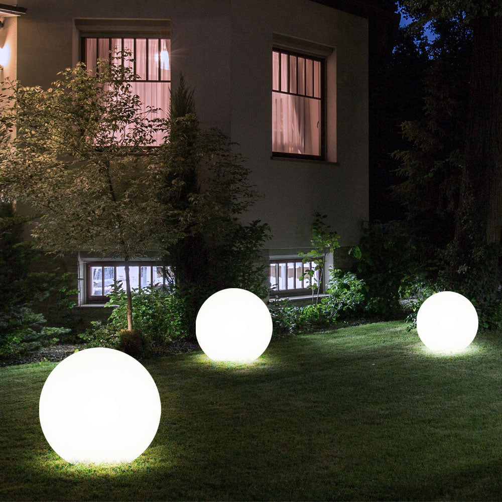 BowLift LumiGlobe weatherproof solar LED garden light shining outdoors, showcasing its round, decorative outdoor garden illumination.
