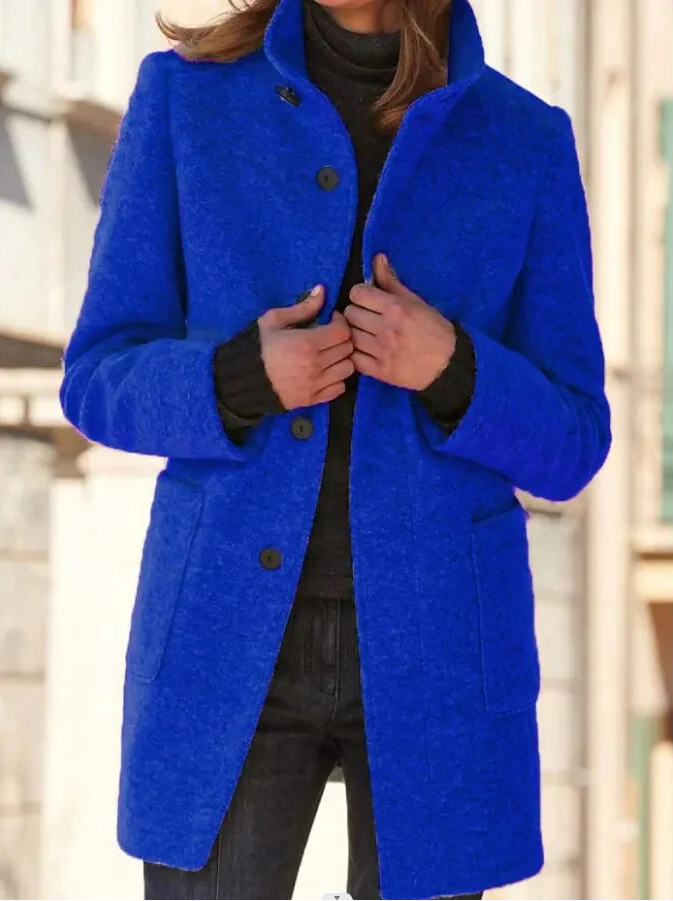 Belro elegant wool coat hanging on a wooden hanger, showcasing its classic design and tailored fit for stylish winter wear.