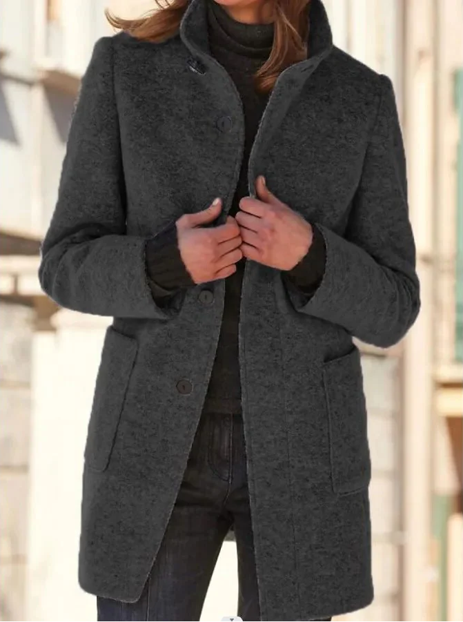 Elegant wool coat by Belro displayed on a hanger, showing its classic design and tailored fit in neutral color.
