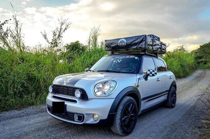 Casavibeo Guana Equipment Wanaka roof top tent set up on a vehicle in outdoor camping setting.
