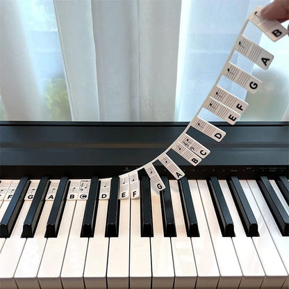 Color-coded BowLift removable piano keyboard note labels with note names for easy learning on piano keys.
