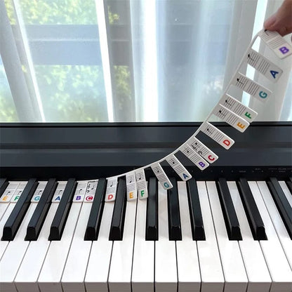 Color-coded BowLift removable piano keyboard note labels stickers on a keyboard for easy music learning and note identification.
