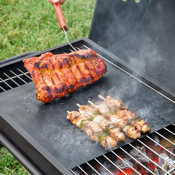 Belro Chef non-stick BBQ grill mat laid out on a grill, designed for easy grilling and preventing food sticking.