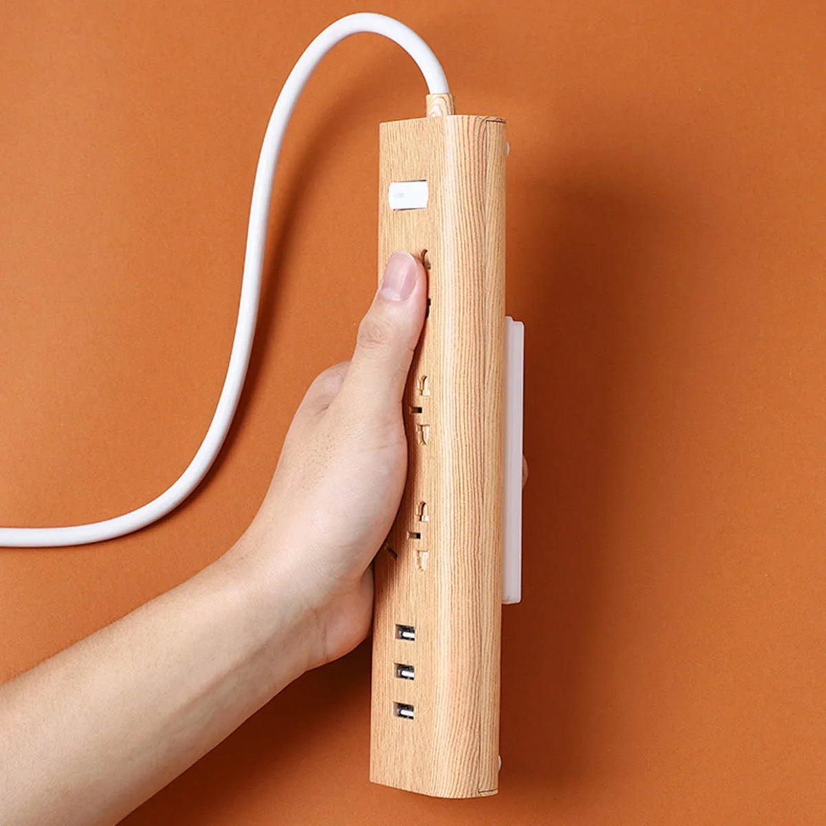 Belro punch-free adhesive socket holder attached to a wall, designed for organizing clothing or accessories in a men's room.