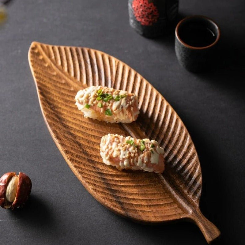 Wooden leaf serving tray by Mivoza with carved leaf design and handles, perfect for kitchen serving and decorative dining.