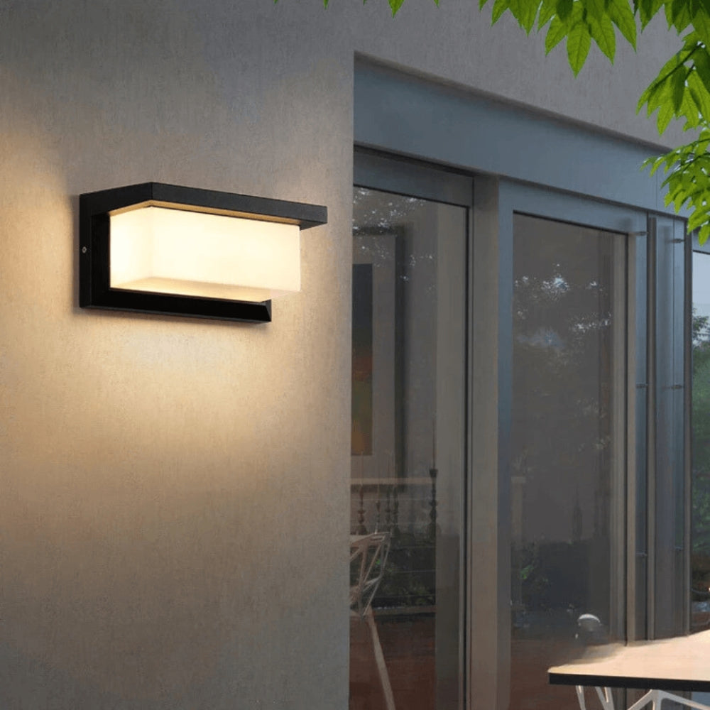 Weatherproof outdoor LED wall light with motion sensor, 20W, mounted on garden wall, ideal for outdoor lighting.