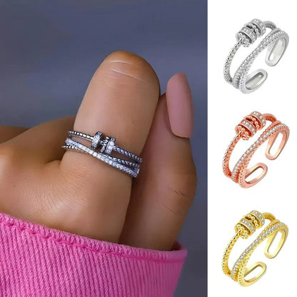 Belro Threanic Triple-Spin Ring showing multiple intertwined silver rings with a sleek, modern design.