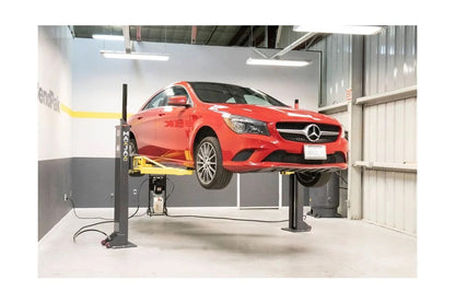 Casavibeo MaxJax portable two-post garage lift with steel arms and hydraulic system for vehicle maintenance and lifting.