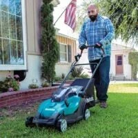 Makita 18V X2 cordless 17-inch residential lawn mower with lithium-ion batteries, shown in use on a well-maintained lawn.
