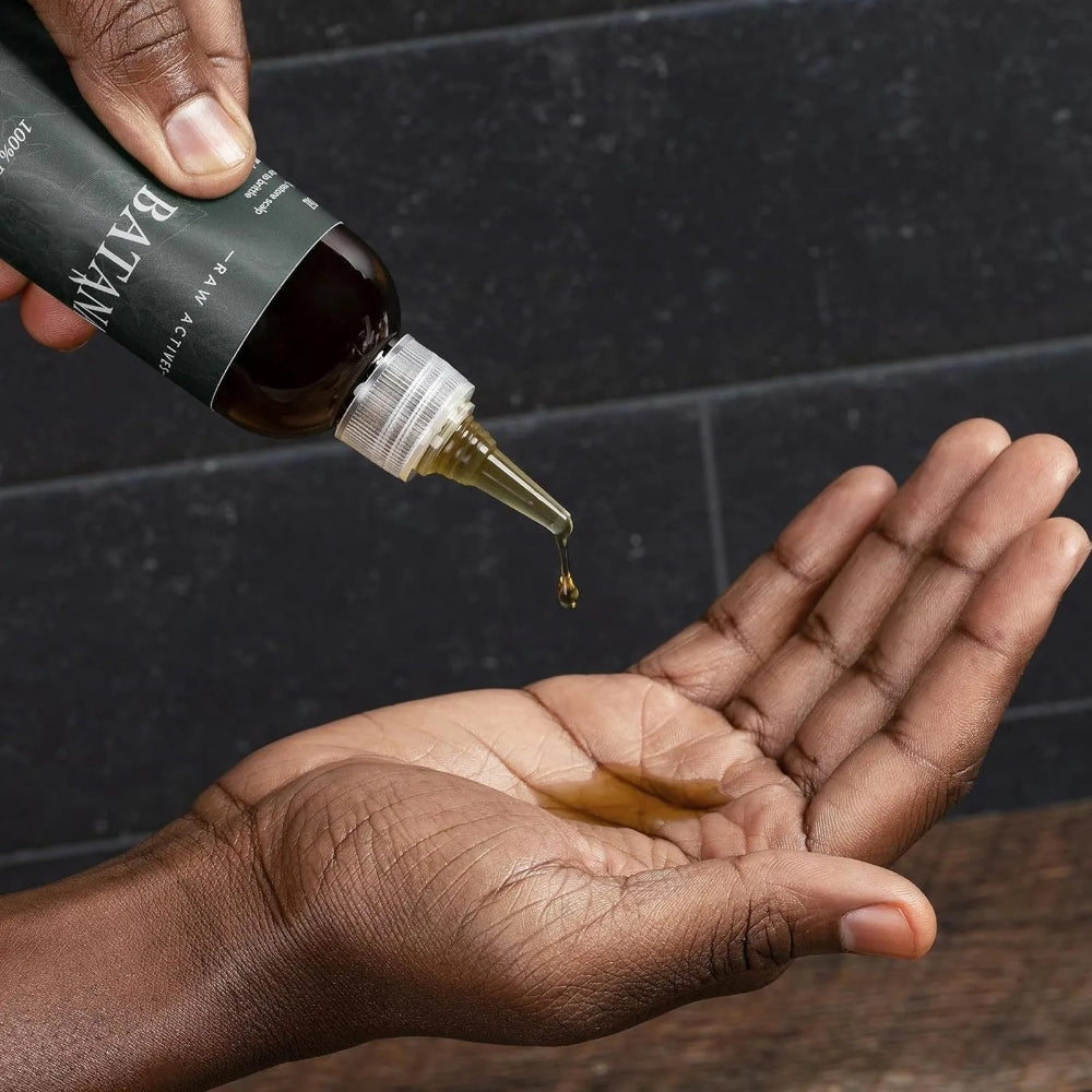Belro Batana Hair Growth Oil scalp moisturizer concentrate in a clear bottle with a dropper for hair and scalp care.