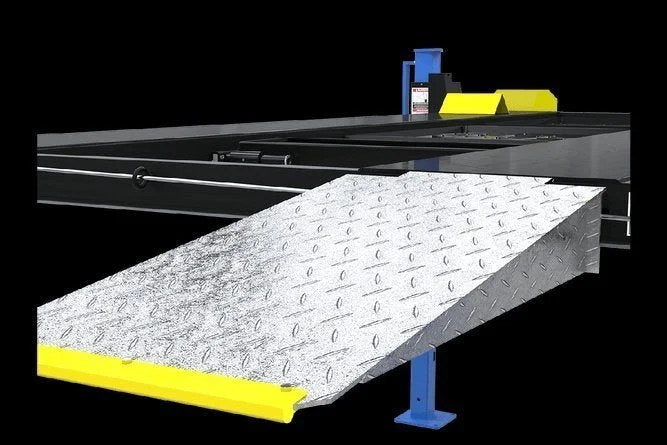 Casavibeo Dannmar D4-9 four-post lift with 9,000-lb capacity, showcasing the sturdy structure and lifting arms in a workshop setting.