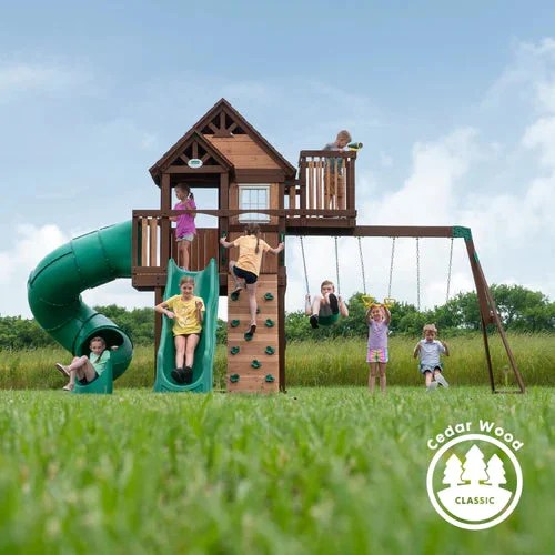 Casavibeo Skyfort III backyard swing set with slides, swings, and climbing features in a sunny outdoor yard setting.