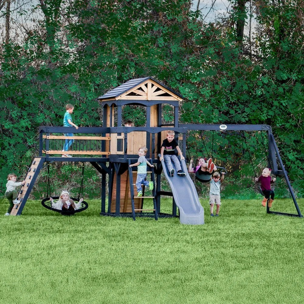 Casavibeo Backyard Discovery Timber Crossing Swing Set with swings, slides, and climbing features in a backyard setting.