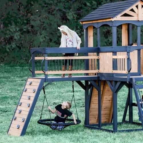 Casavibeo Backyard Discovery Timber Crossing Swing Set with slides, swings, and climbing features in a backyard setting.