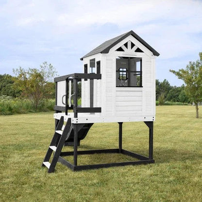 Casavibeo Backyard Discovery Sweetwater Heights elevated playhouse with slide, climbing wall, and outdoor play features in a lush backyard setting.
