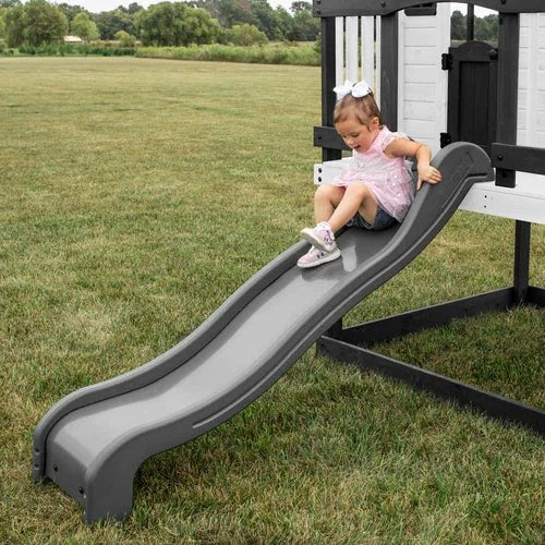 Casavibeo Backyard Discovery Sweetwater Heights elevated playhouse with slide and climbing ladder in a backyard setting.