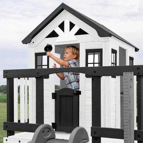 Casavibeo Backyard Discovery Sweetwater Heights elevated playhouse with slide and climbing ladder in a backyard setting