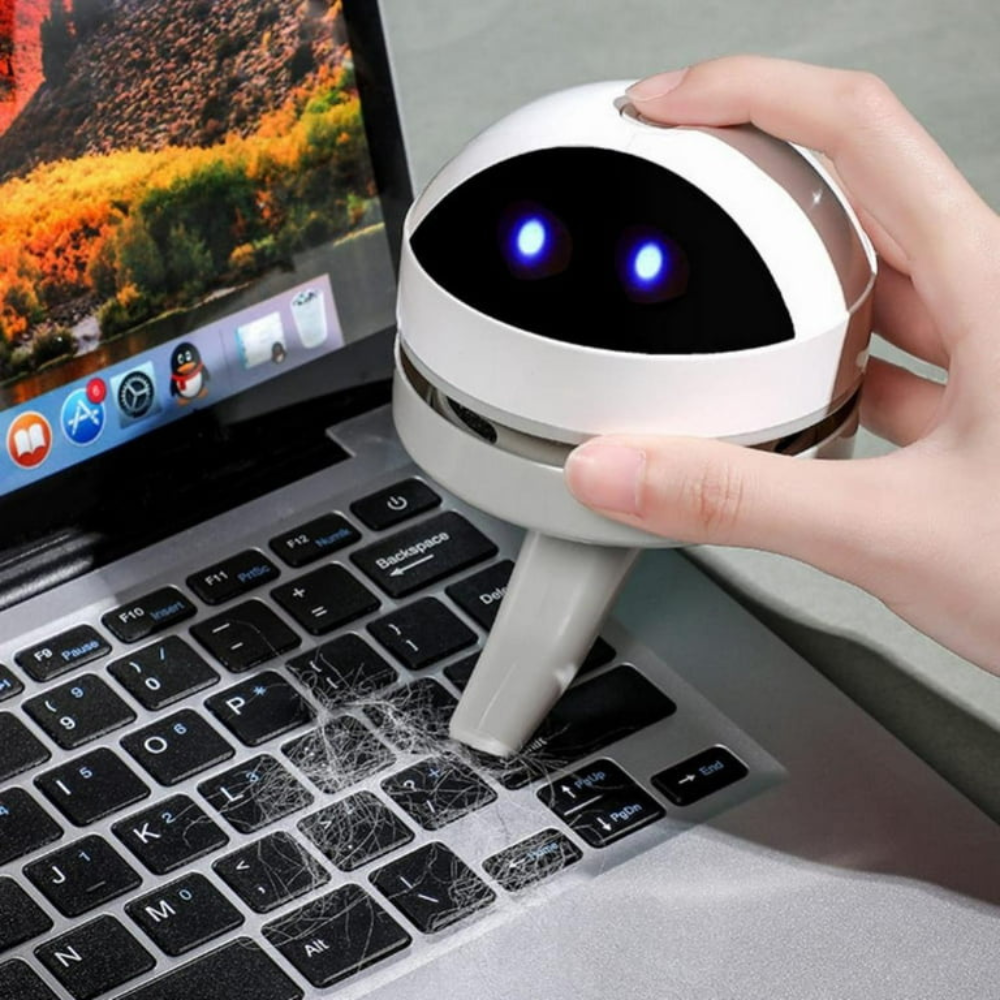 Belro compact USB charging mini desk vacuum cleaner robot for electronics cleaning on a workspace.