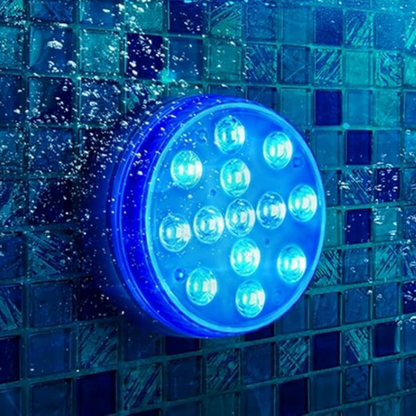 Colorful Belro submersible LED pool party lights illuminating a backyard pool with vibrant rainbow colors.