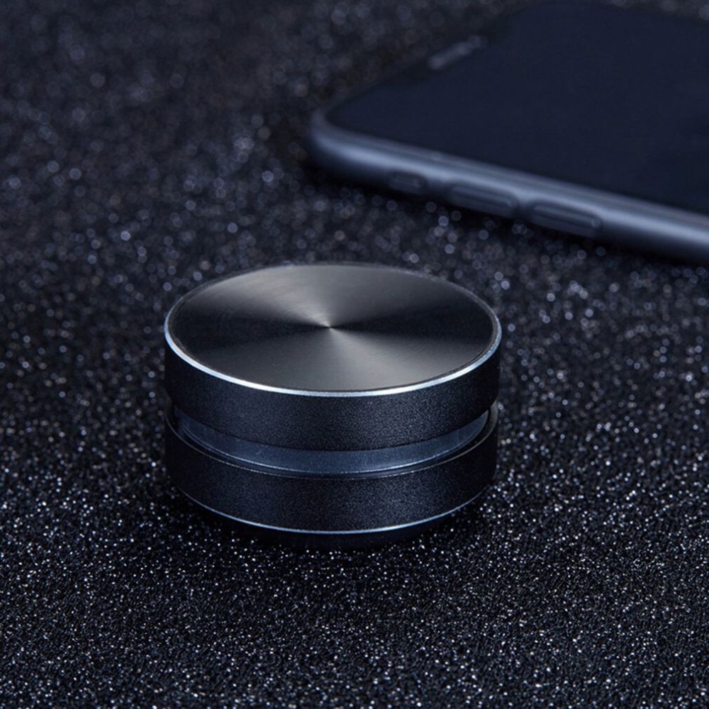 Belro Bone Induction Speaker showcasing a sleek black device with a circular speaker surface and control buttons, designed for surface audio.