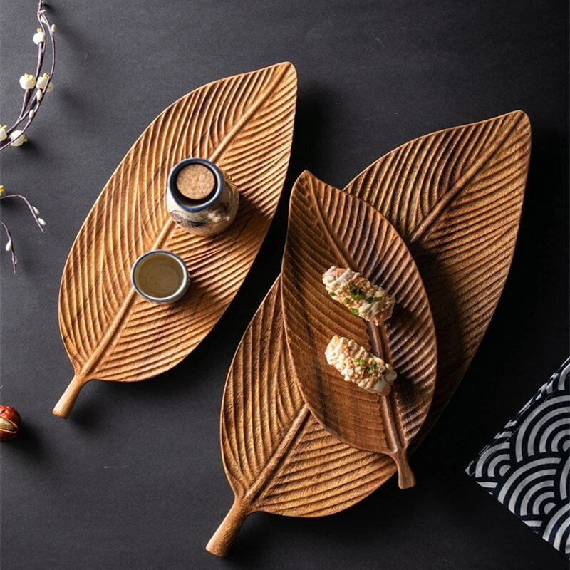 Wooden leaf serving tray with carved decorative design and handles, ideal for kitchen serving and dining displays.