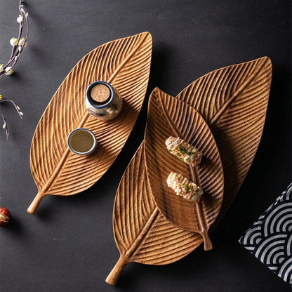 Wooden leaf serving tray with carved decorative design and handles, ideal for kitchen serving and dining displays.