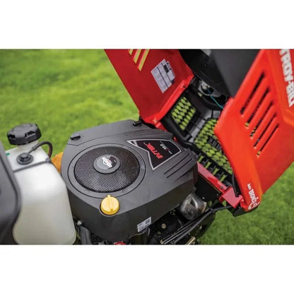 Casavibeo Troy-Bilt Bronco 42-inch riding lawn mower with a cutting deck, seat, and steering wheel on a grassy lawn.
