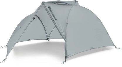 Sea to Summit Telos TR3 tent set up outdoors, showcasing its lightweight, three-person design with rainfly and ventilation features.