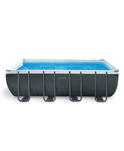 Intex Ultra XTR above ground pool with a clear blue water surface and a matching solar cover, outdoors in a backyard setting.