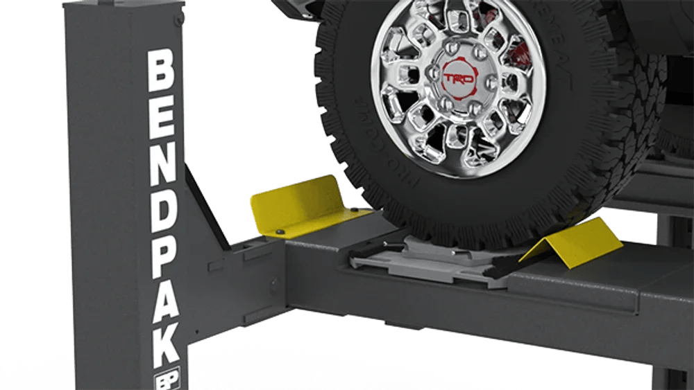 Casavibeo BendPak 14,000 lb. capacity automotive lift with turnplates and slip plates, shown in a workshop setting.