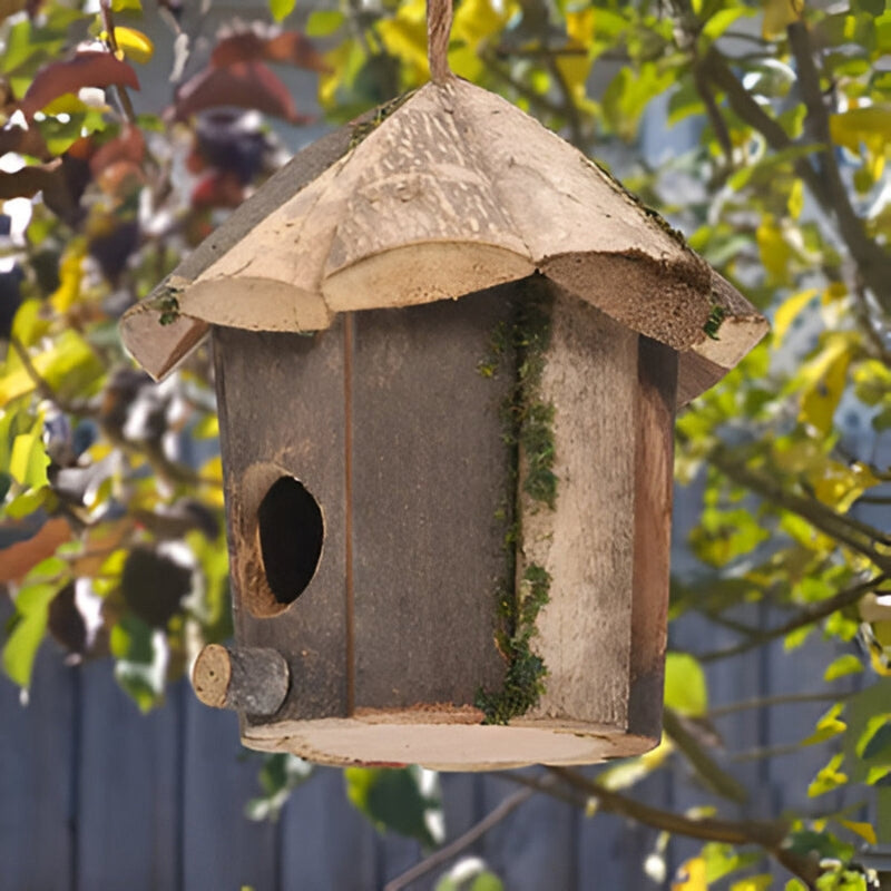 Wooden bird house by Mivoza with hut design, hanging cord, weatherproof finish, suitable for garden bird nesting.