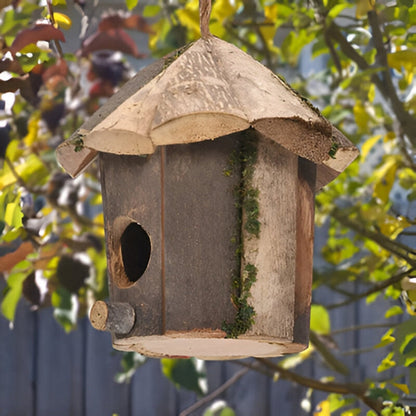 Wooden bird house by Mivoza with hut design, hanging cord, weatherproof finish, suitable for garden bird nesting.