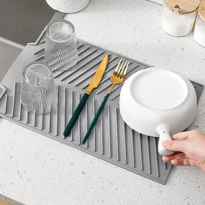 Belro silicone countertop dish drying mat on kitchen counter, flexible and non-slip surface for drying dishes and utensils.