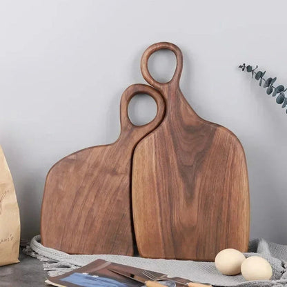 Set of two walnut wooden cutting boards from Mivoza with loop handles for hanging, ideal for kitchen prep and presentation.