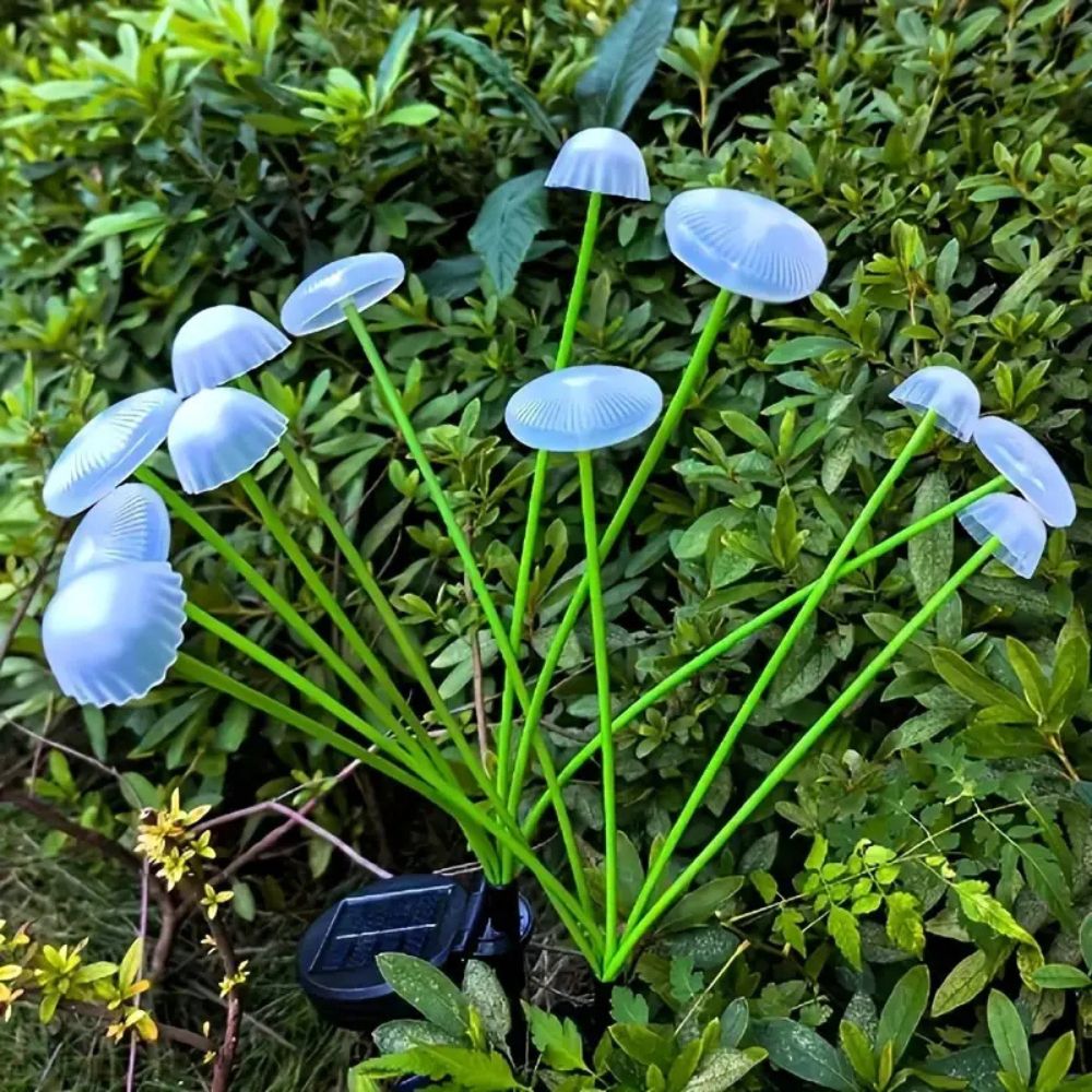 Belro Solar Swaying Mushroom Garden Decor Lights in a lush outdoor garden setting, adding whimsical illumination.
